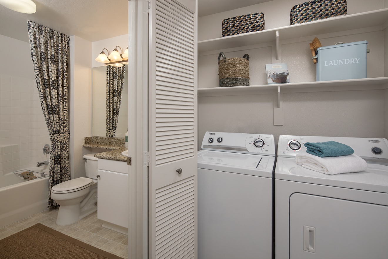 Interior view of laundry and bathroom at Rancho Santa Fe Apartment Homes in Tustin, CA.