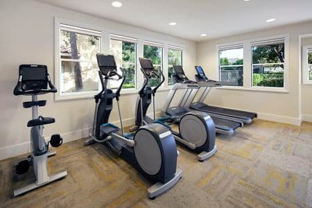 Interior view of fitness center at Rancho Santa Fe Apartment Homes in Tustin, CA.
