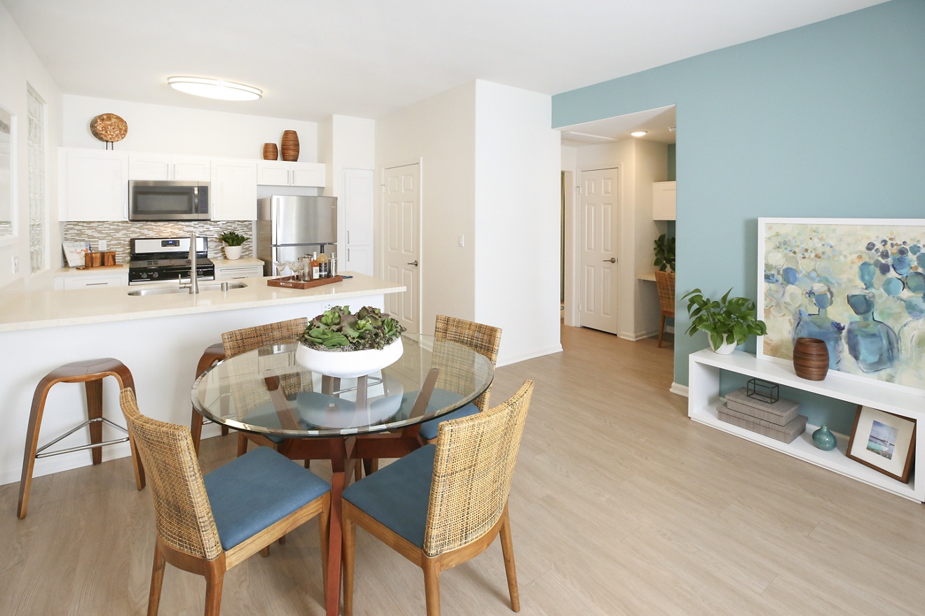 Interior view of kitchen and dining room at Del Rio Apartment Homes in Mission Valley, CA.