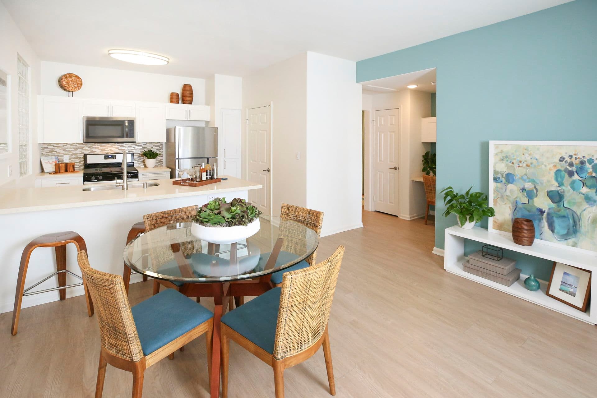 Interior view of kitchen and dining room at Del Rio Apartment Homes in Mission Valley, CA.