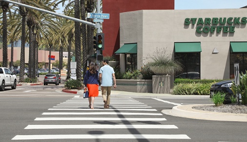 Couple crossing the street at Del Rio Apartment Homes in Mission Valley, CA.