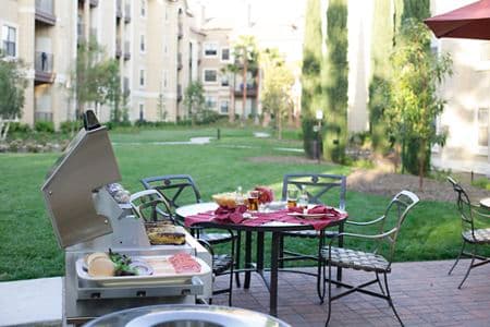 Exterior view of BBQ grill and outdoor patio at Monte Vista Apartment Homes in Mission Valley, CA.