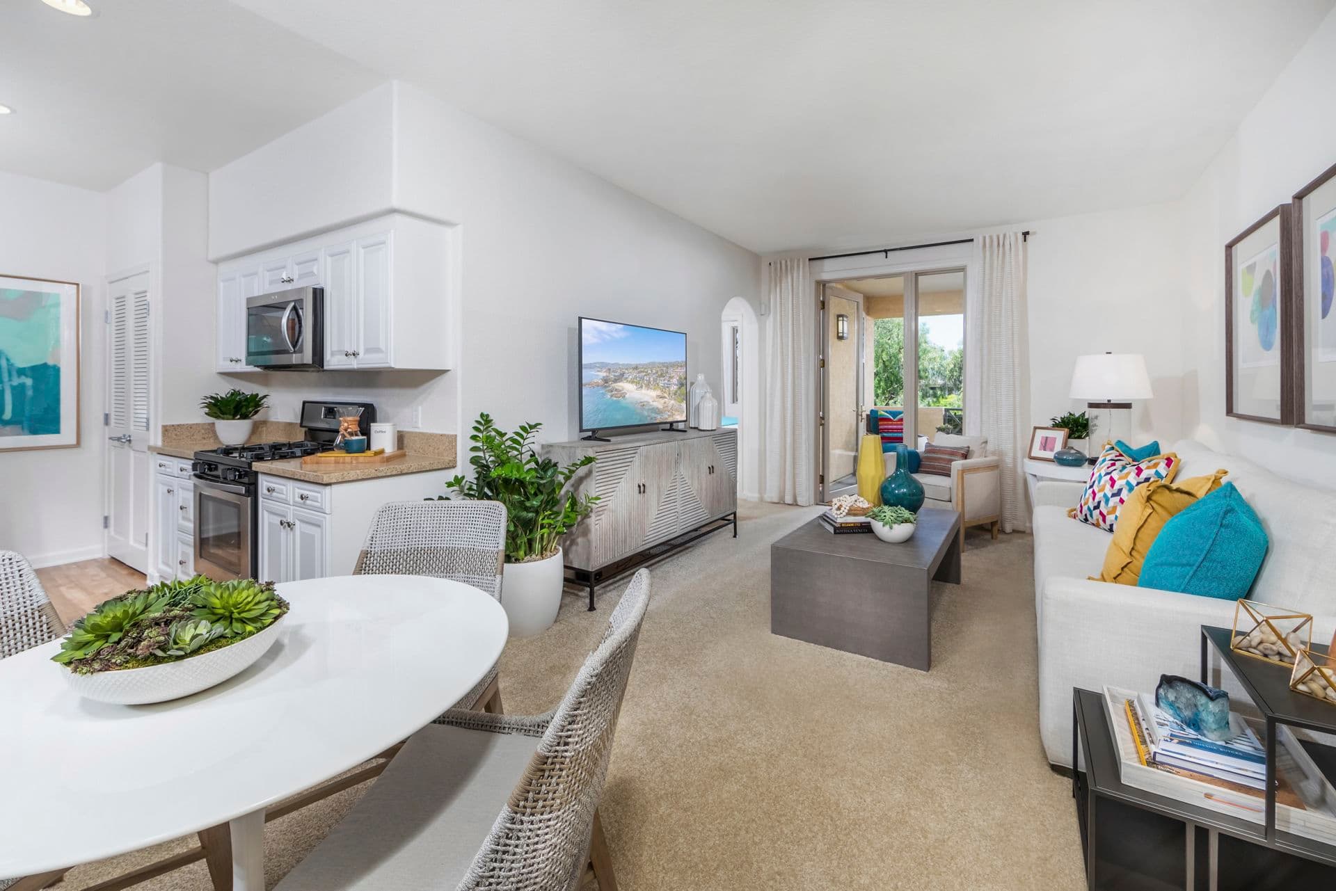 Interior view of living room and dining room at Pacific View Apartment Homes in Carlsbad, CA.