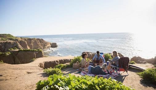Image of a group of people gathered on the cliffs in La Jolla, California. 