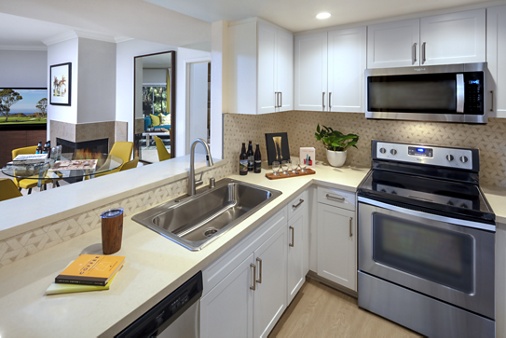 Interior view of kitchen and living room at The Villas of Renaissance Apartment Homes in San Diego, CA.