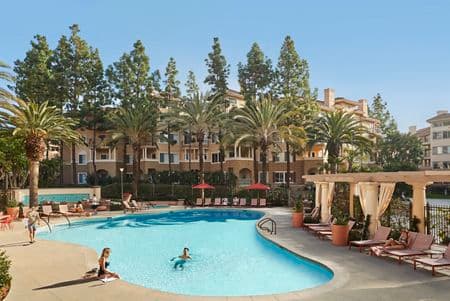 People spending time by pool at The Villas of Renaissance Apartment Homes in San Diego, CA.