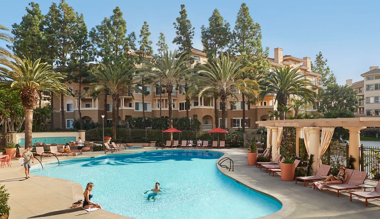 People spending time by pool at The Villas of Renaissance Apartment Homes in San Diego, CA.