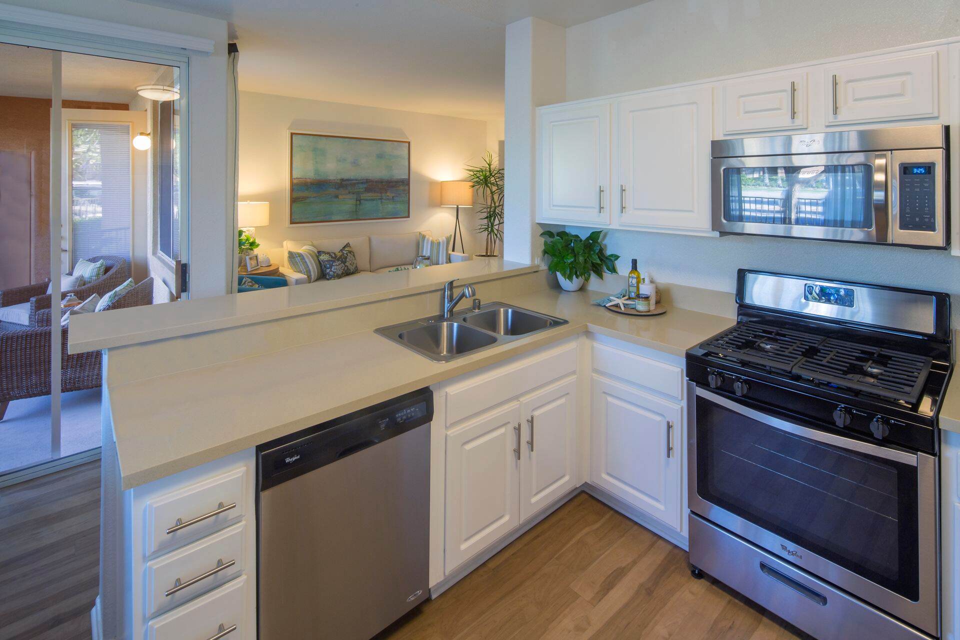 Interior view of kitchen and living area at Torrey Hills Apartment Homes in San Diego, CA.