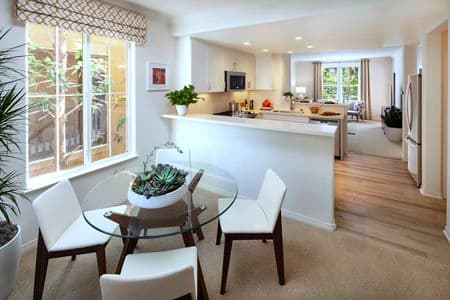 View of kitchen and dining room at Torrey Ridge Apartment Homes in Carmel Valley, CA.