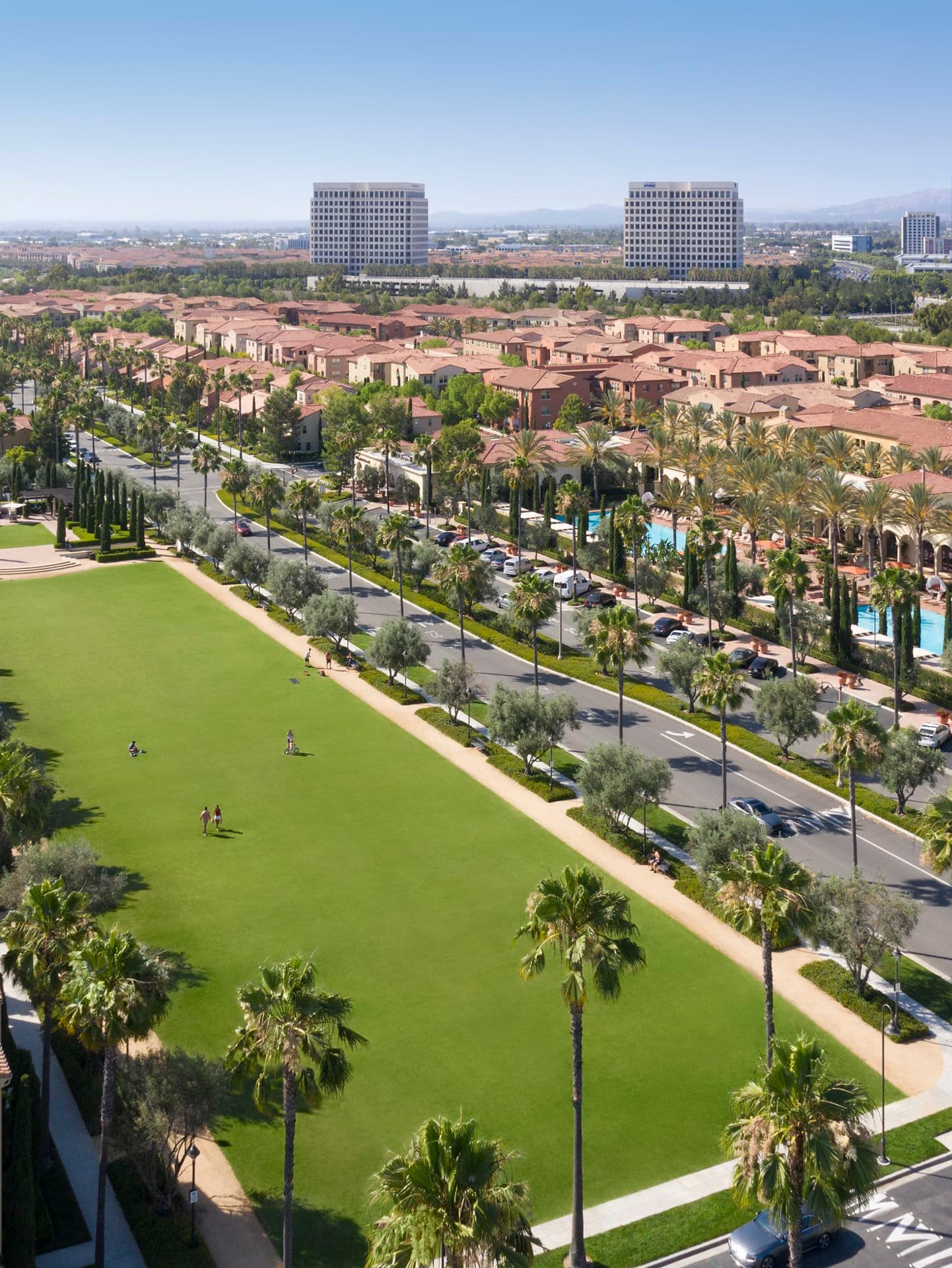 Aerial view of people at courtyard at Los Olivos at Irvine Spectrum Apartment Homes in Irvine, CA.