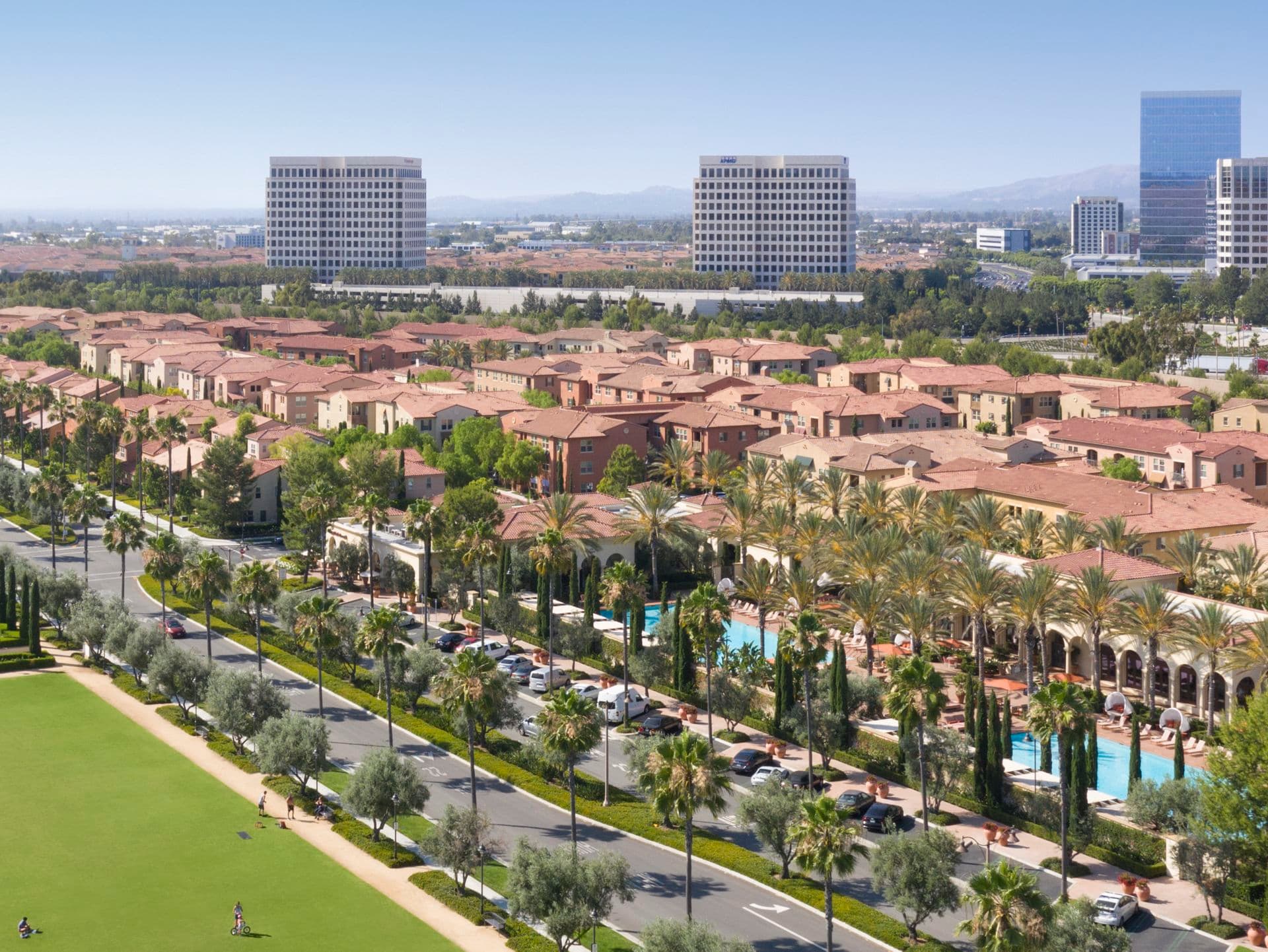 Aerial view of people at courtyard at Los Olivos at Irvine Spectrum Apartment Homes in Irvine, CA.