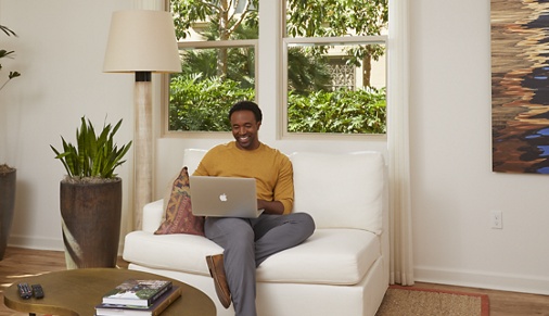 Man working from home in living room at an Irvine Company Apartment Community.