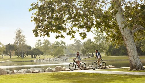 Exterior view of people riding bikes at an Irvine park in Irvine, CA.