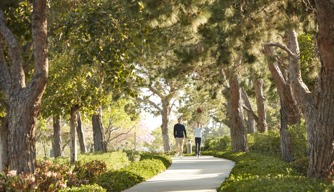 Exterior view of people walking on ped pathway at Paseo Westpark in Irvine, CA.