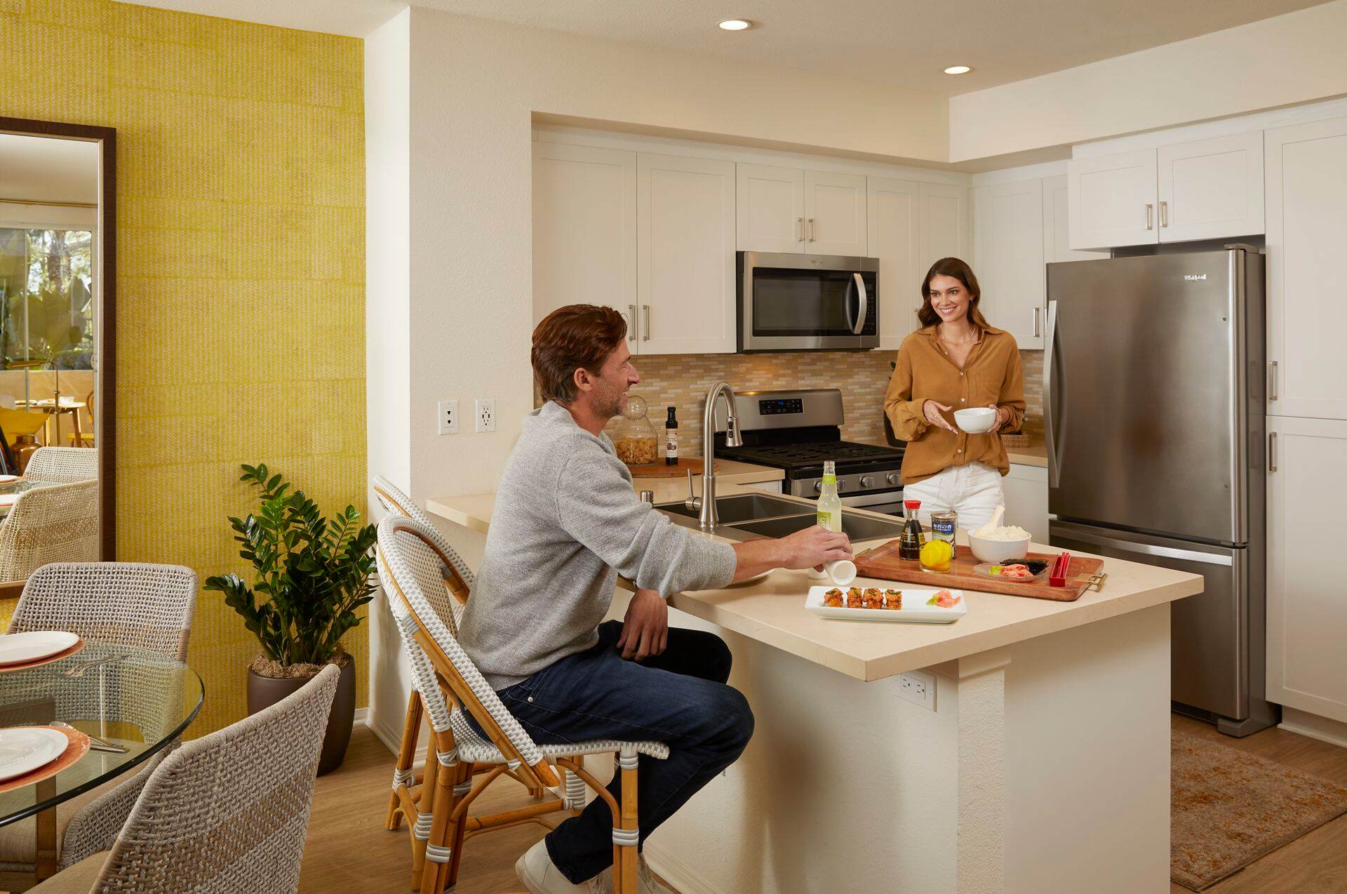 Interior view of couple in the kitchen at Turtle Ridge Apartment Homes in Irvine, CA.
