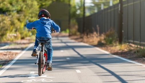 Australian boy riding his bicycle on bike lane on a day, South Australia