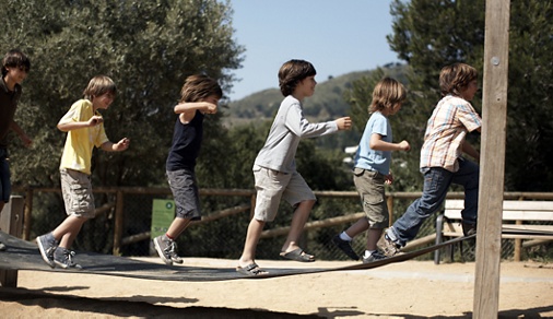 boys jump on playground structure