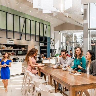 Interior view of people at Pacific Kitchen Market at 2121 Avenue of the Stars Office Properties in Los Angeles, CA.