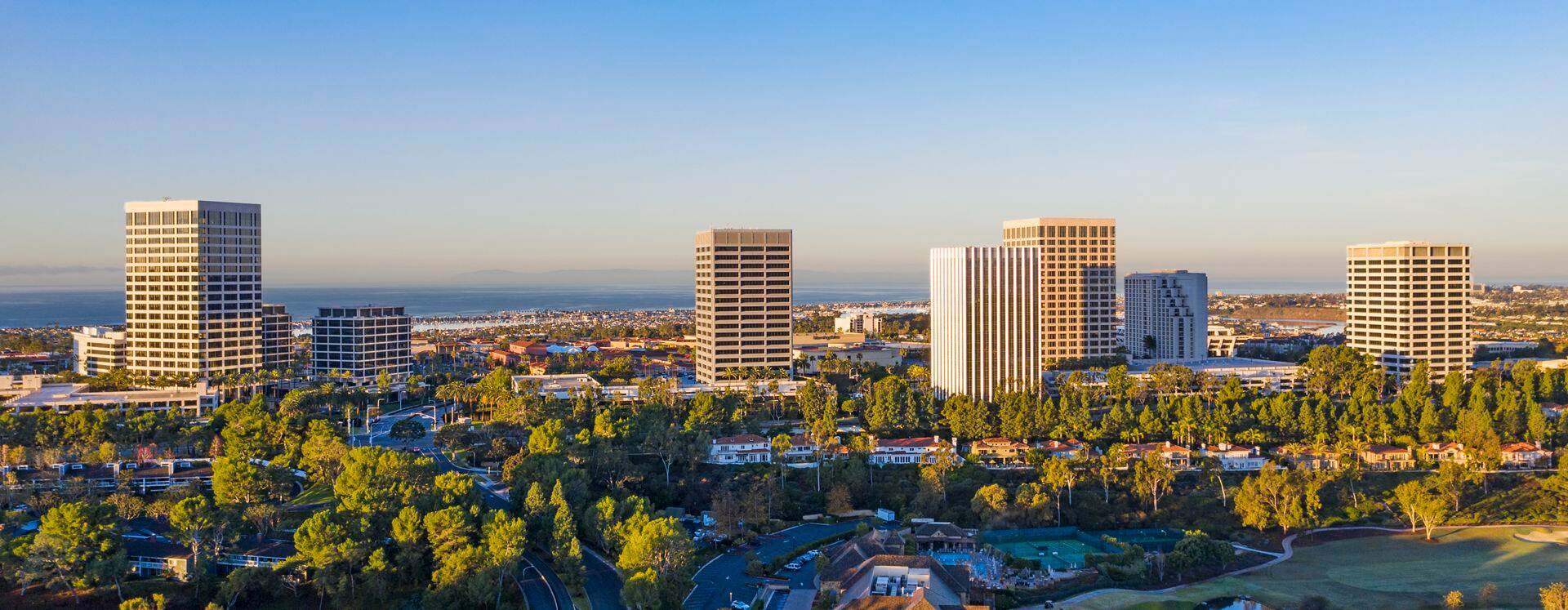Aerial photography of the Newport Center area featuring snowy mountains in Newport Beach, CA