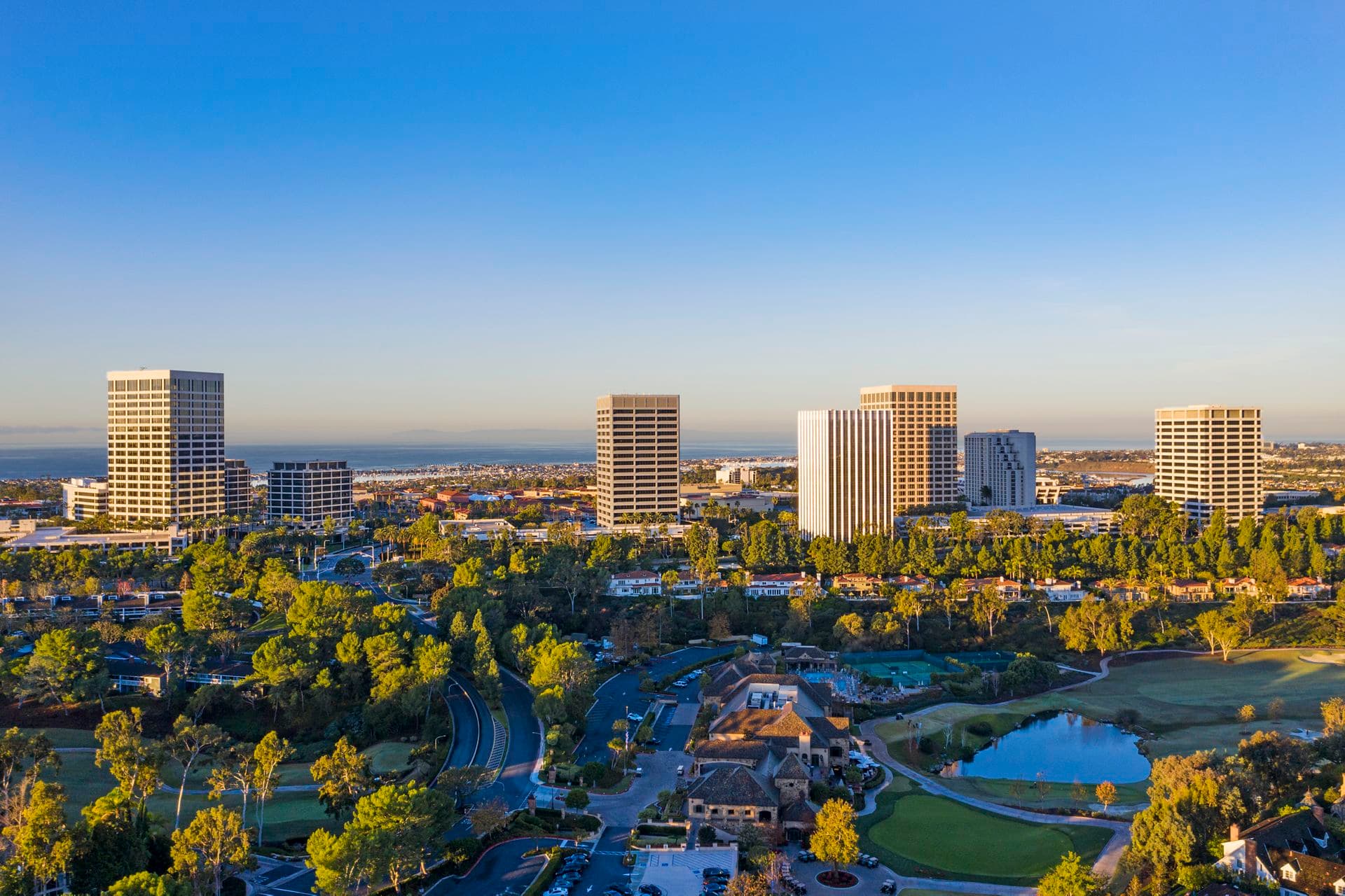 Aerial photography of the Newport Center area featuring snowy mountains in Newport Beach, CA